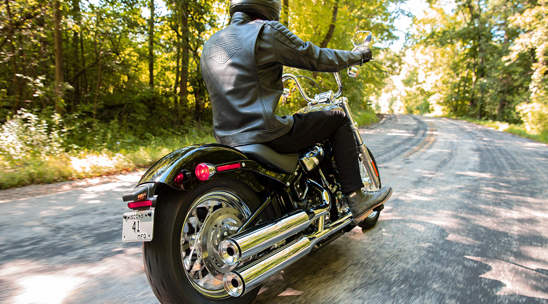 motorcycle on road in wooded area